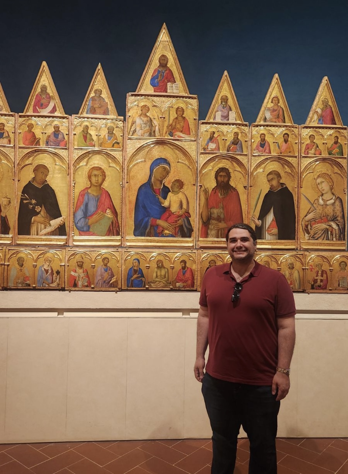 Tony Del Aversano standing next to Simone Martini, Saint Catherine of Alexandria Polyptych, 1320, Tempera and gold on panel, Pisa: Museo nazionale di San Matteo.