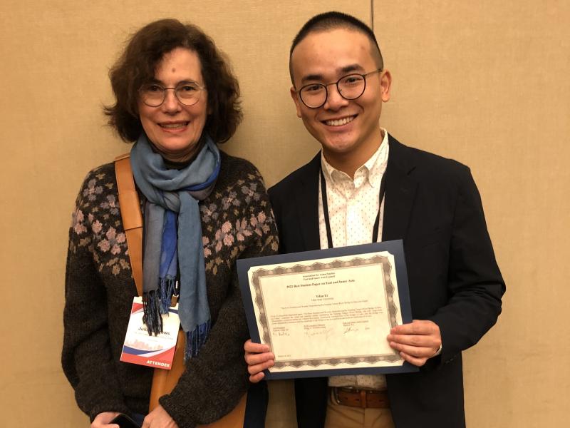 Yifan Li holding award with Judy Andrews 