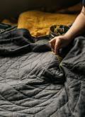 A person sewing a quilt.