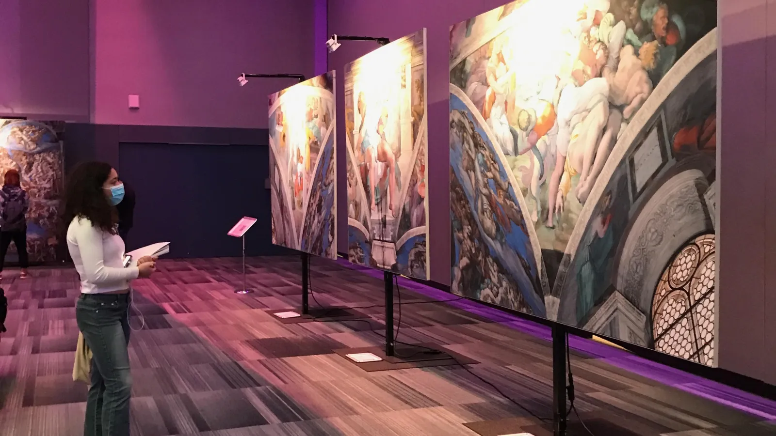student looking at Michelangelo exhibit