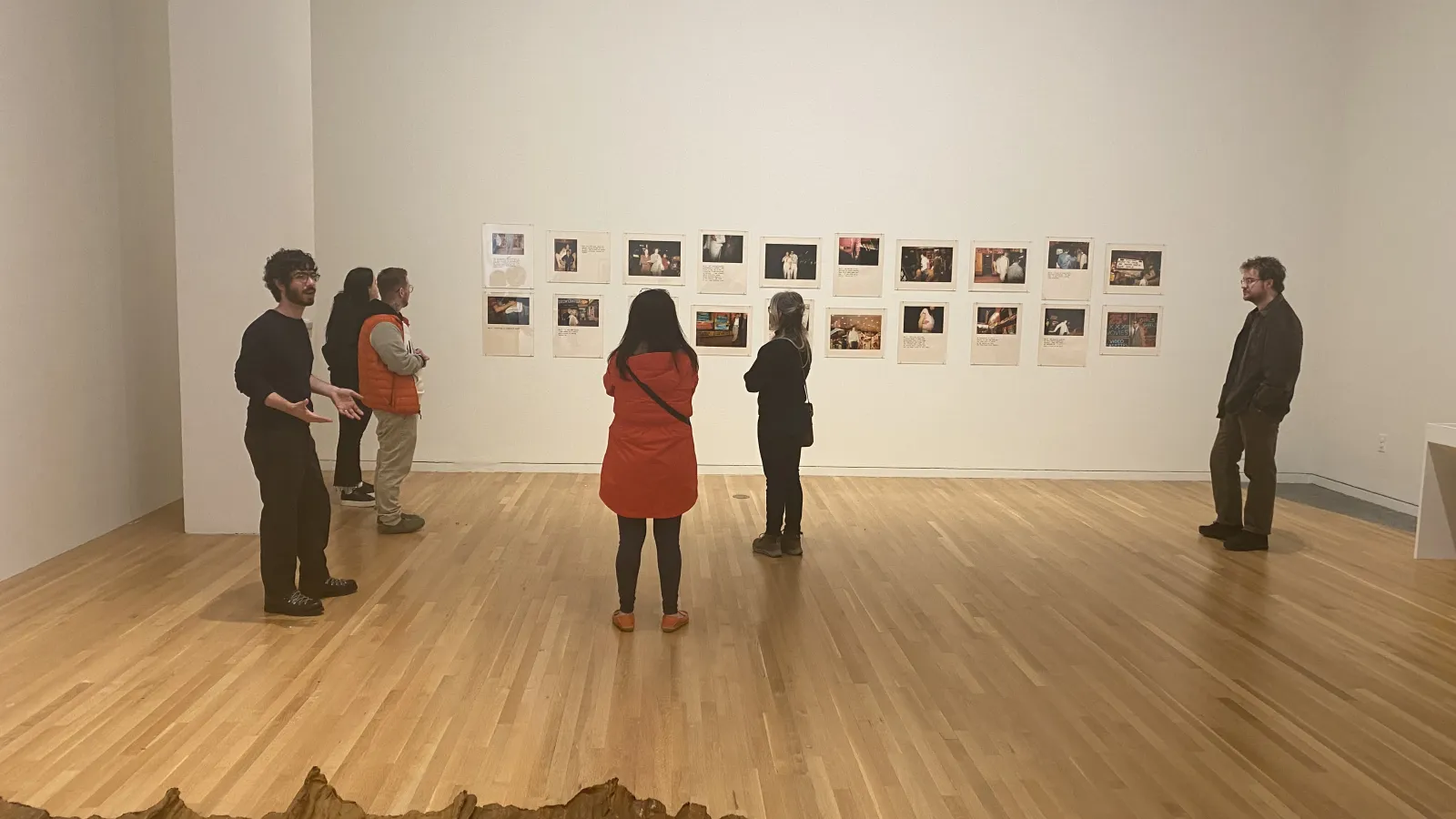 history of art dept. members in gallery in front of gallery wall looking at art