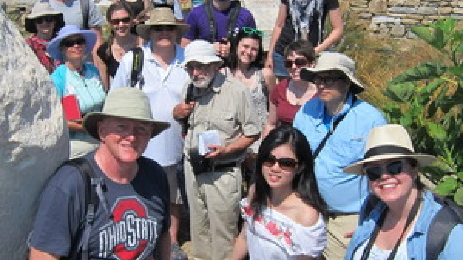 Photograph of Professor Mark Fullerton with a group of students. 
