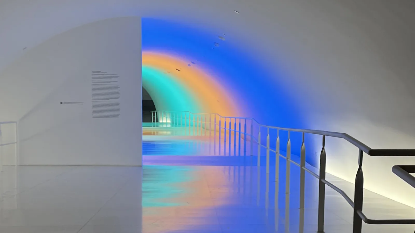 tunnel with green, orange, and blue lights
