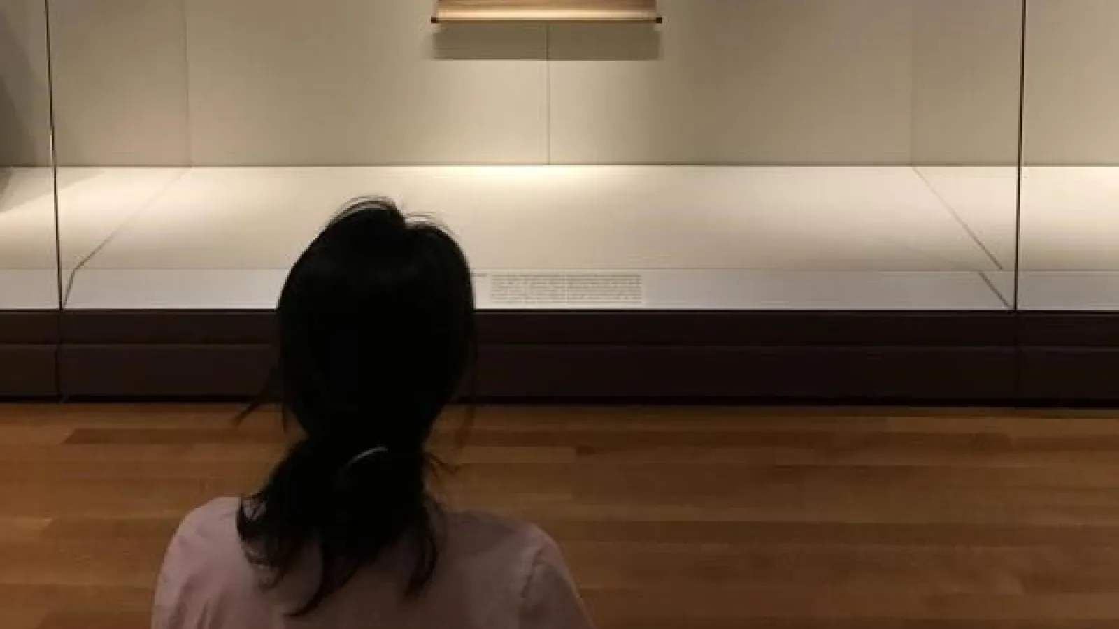 Christy Sher from the back looking at an artwork