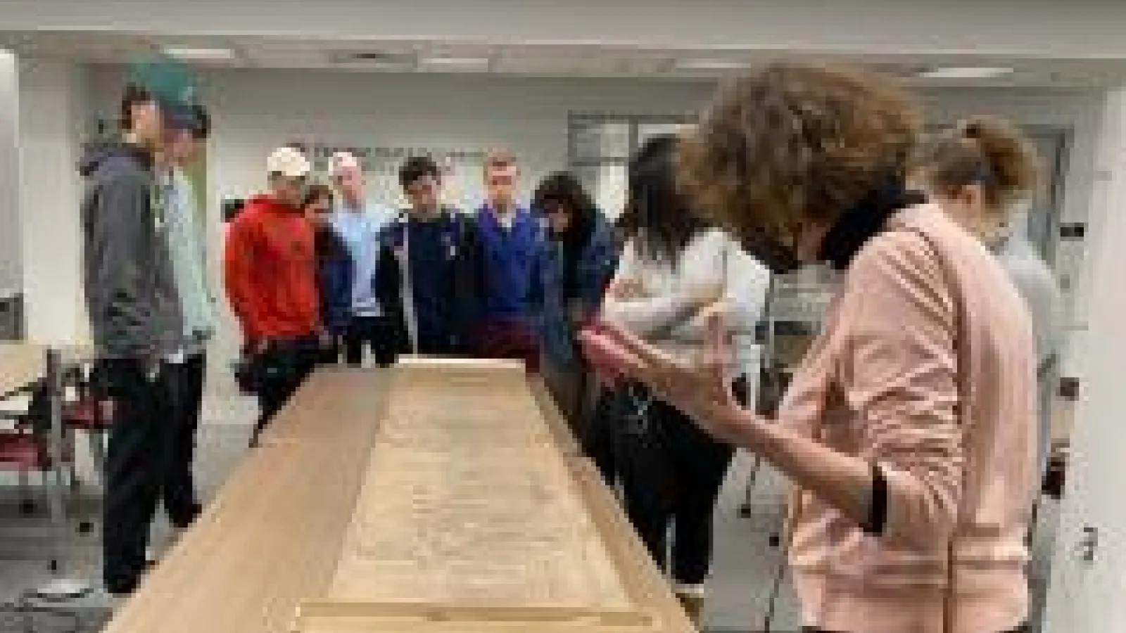 Professor Andrews and students looking at a scroll painting