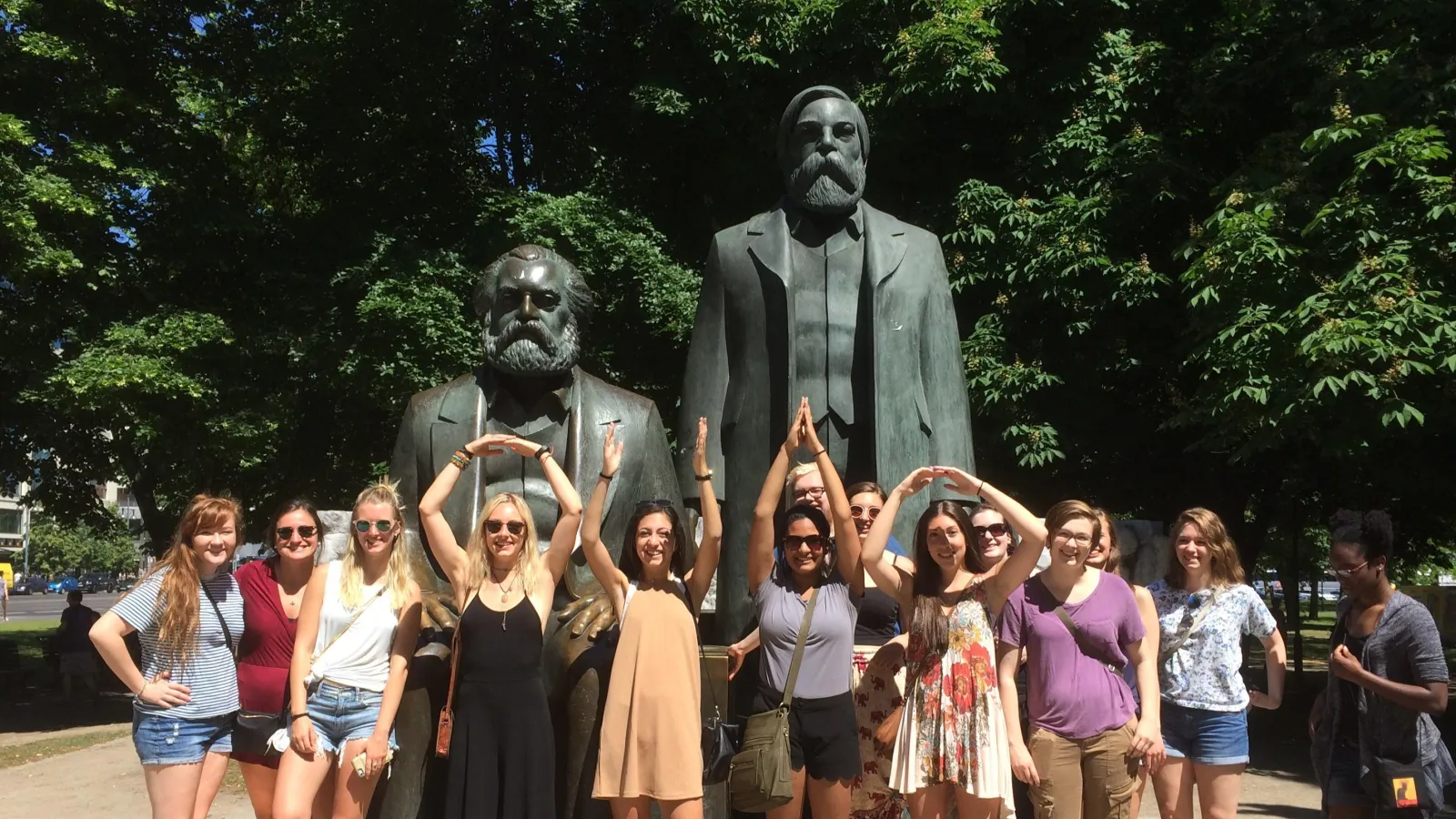 Image: students in front of Marx & Engels sculpture near Alexanderplatz, Berlin