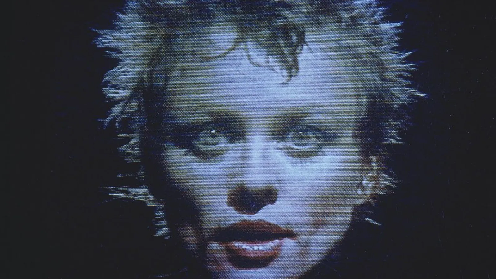 Grainy headshot photo of Laurie Anderson from the 1980s