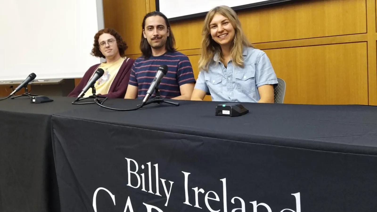 three graduate students smiling for photo at Billy Ireland panel discussion for Comic Crossroads Columbus