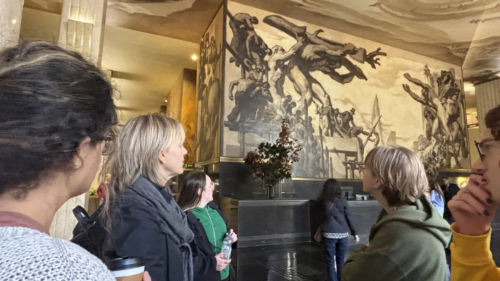 Dr. Jodie Patterson observing an art piece with two students in the Museum of Modern Art