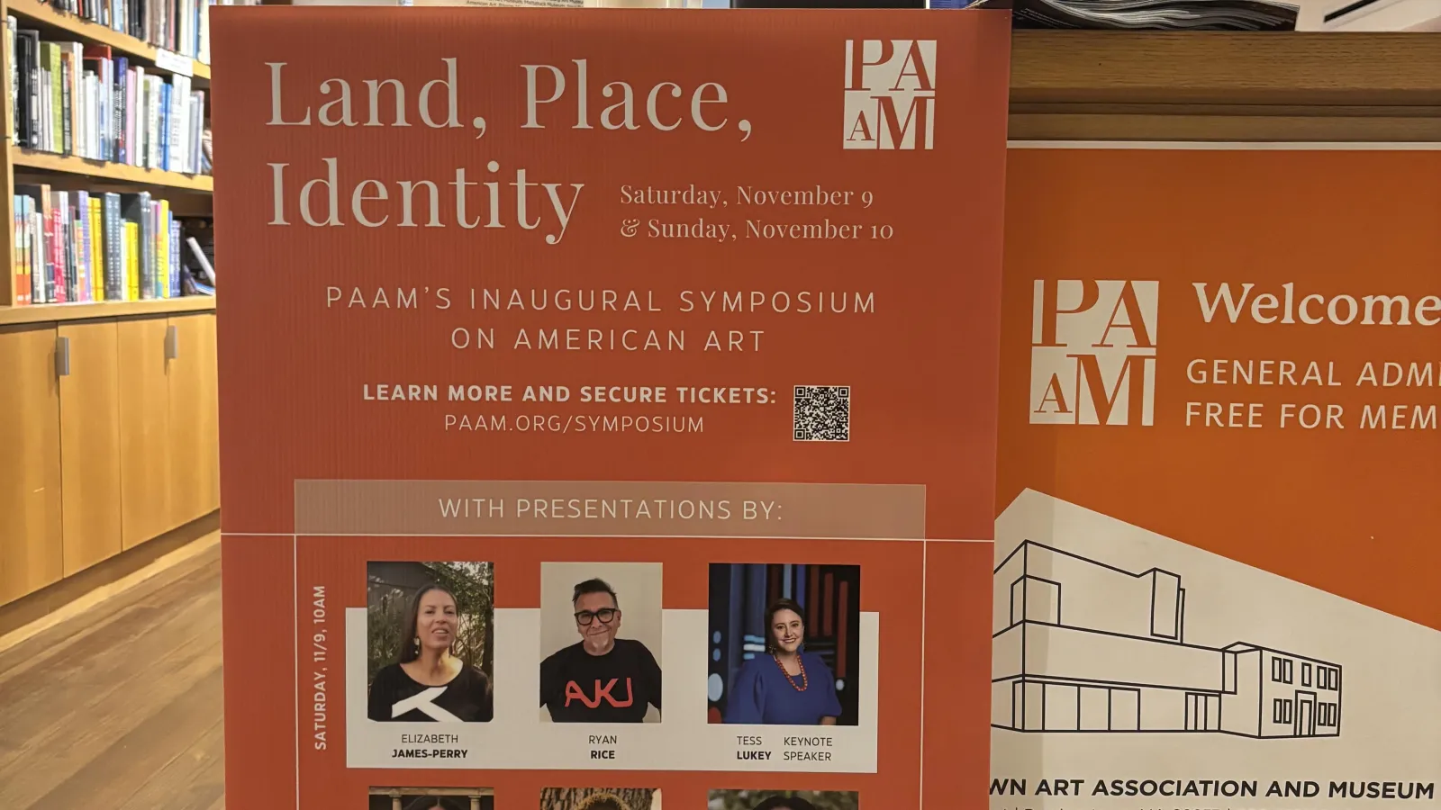 Orange PAAM symposium flyer hanging in a library