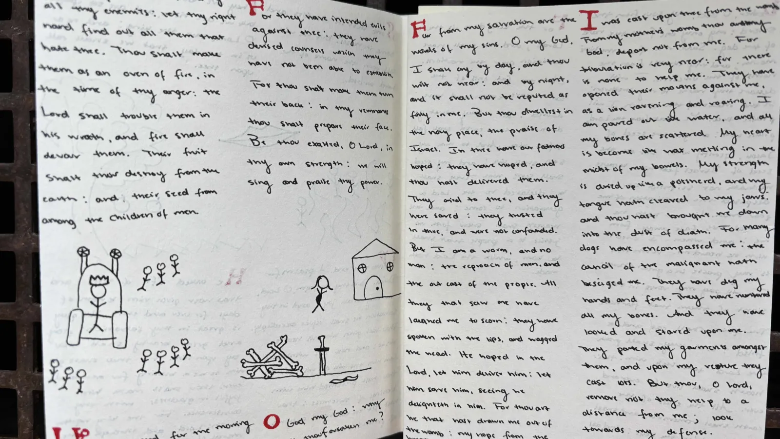 two open pages of text with small drawings, one of a house