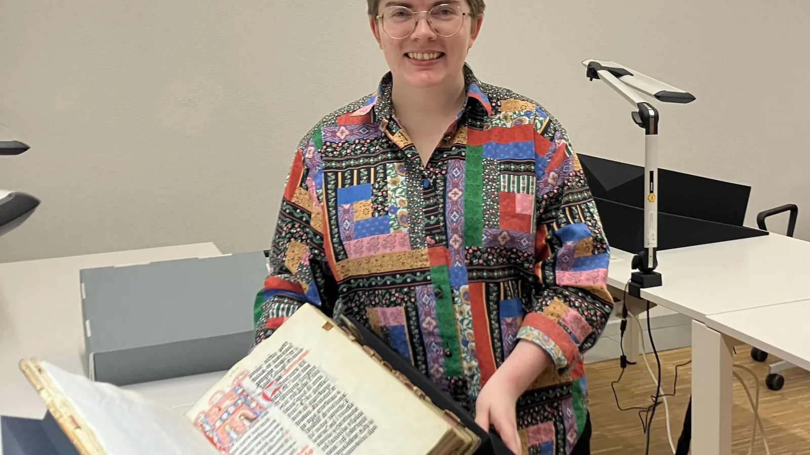 Margaret Wilson holding fifteenth century manuscript