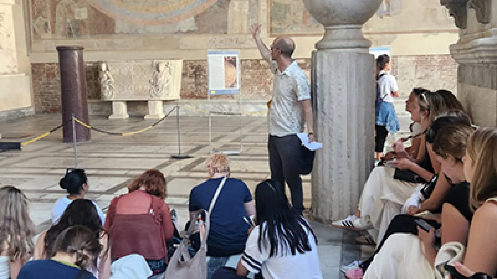 Seated students listen as Professor Whittington speaks during "Medieval Art in Italy"