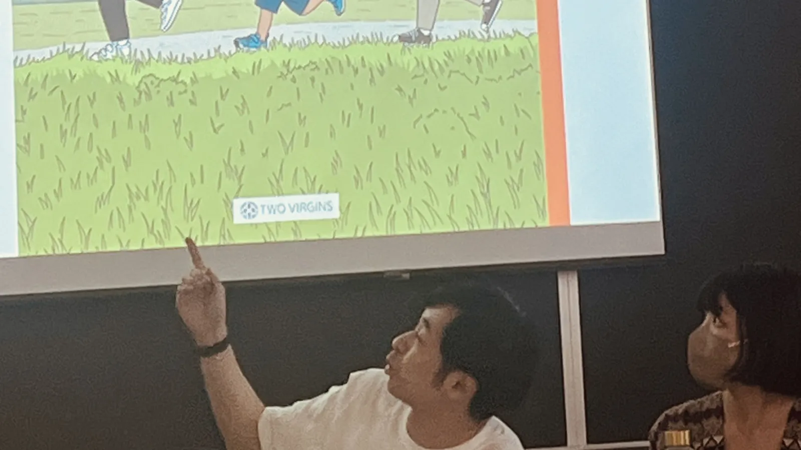 the manga artist pointing at his art