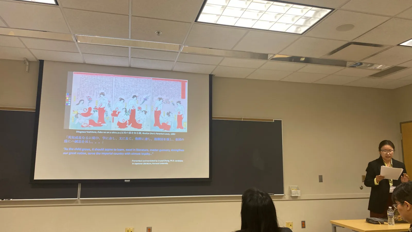 Christy presenting in front of a slideshow