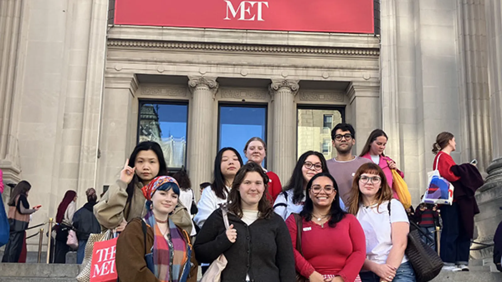 Students pose on the entry stairs to the Met Museum of Art 