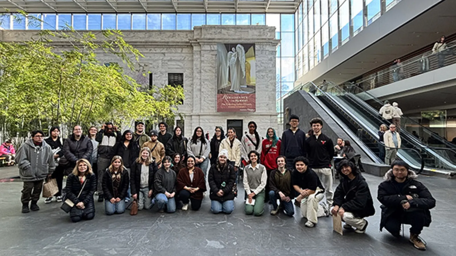 Entire group poses at entry to museum. 
