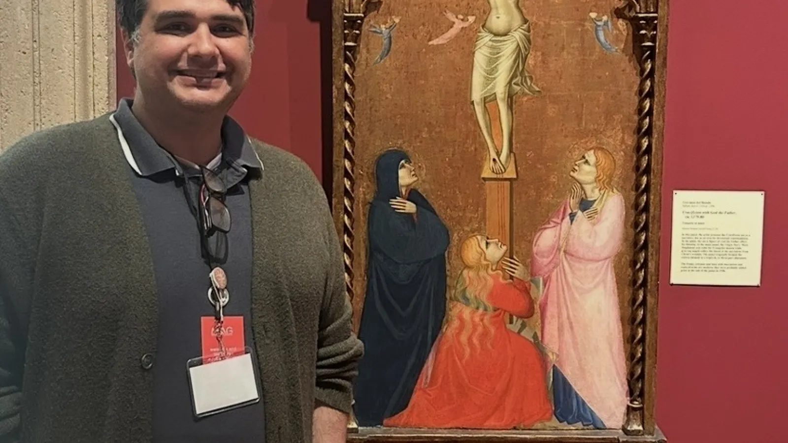 Tony Del Aversano standing by Medieval artwork
