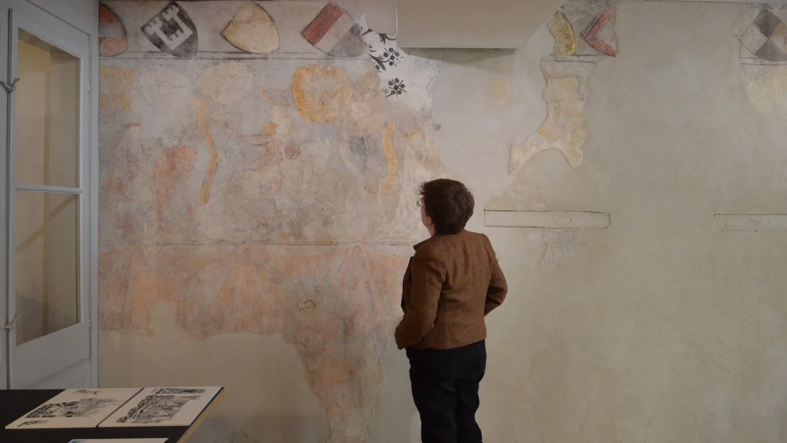 Viewing a mural of courtly hunting at Brunngasse 8, Zurich, in the "ballroom" of a 14th-century Jewish home.