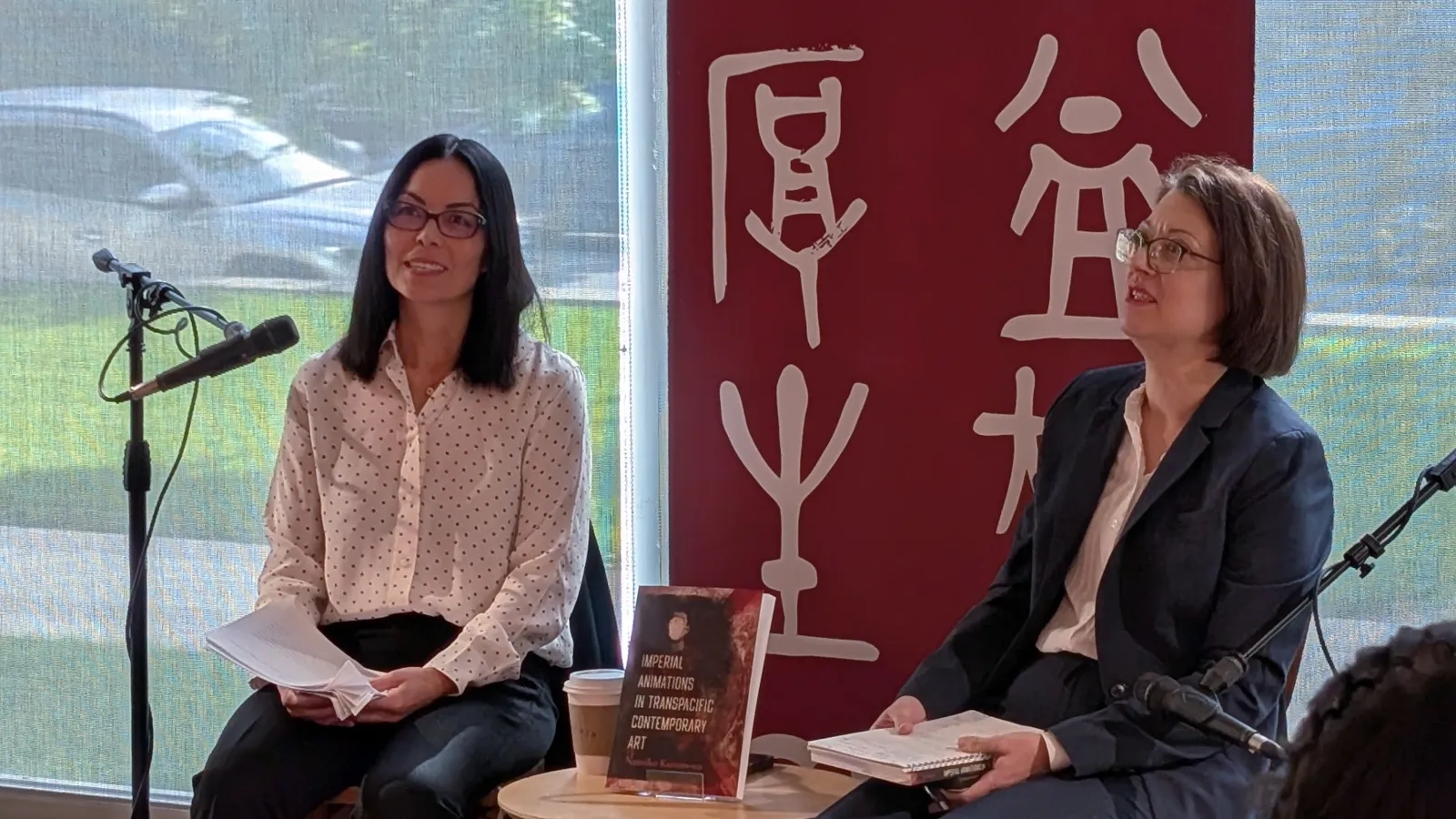 Namiko sitting with Chelsea to present her new book