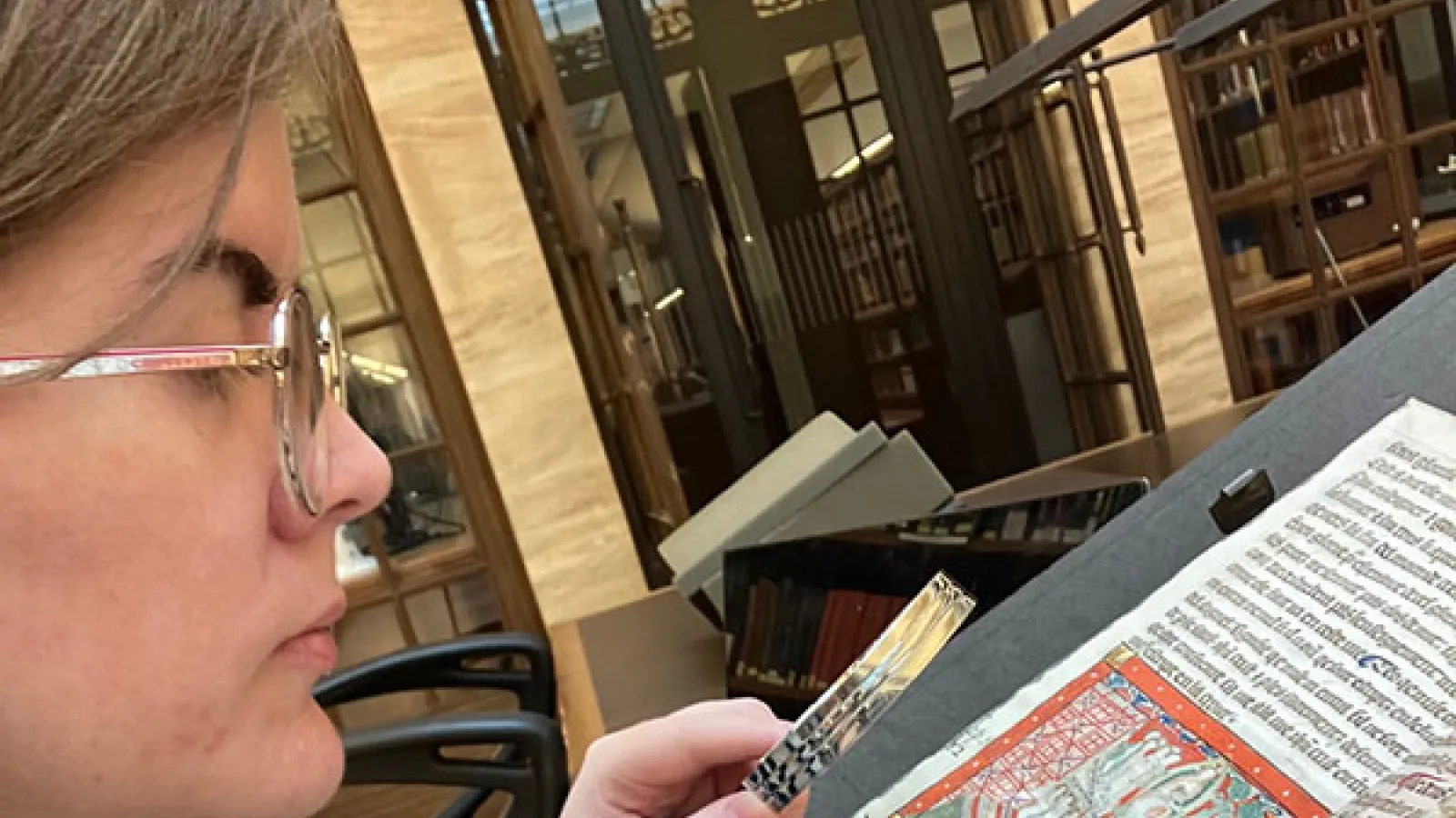 Maggie Wilson examining MS Bodley 401.