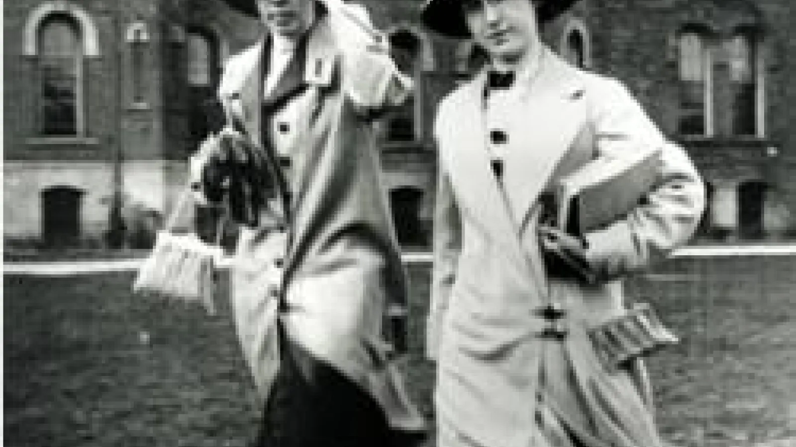 2 women walking next to each other in black and white