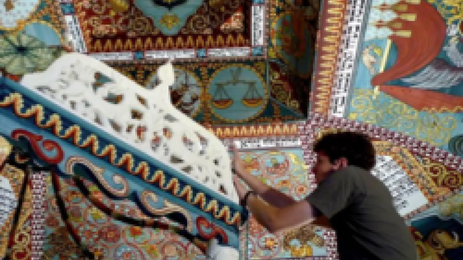man tinkering with a sculpture