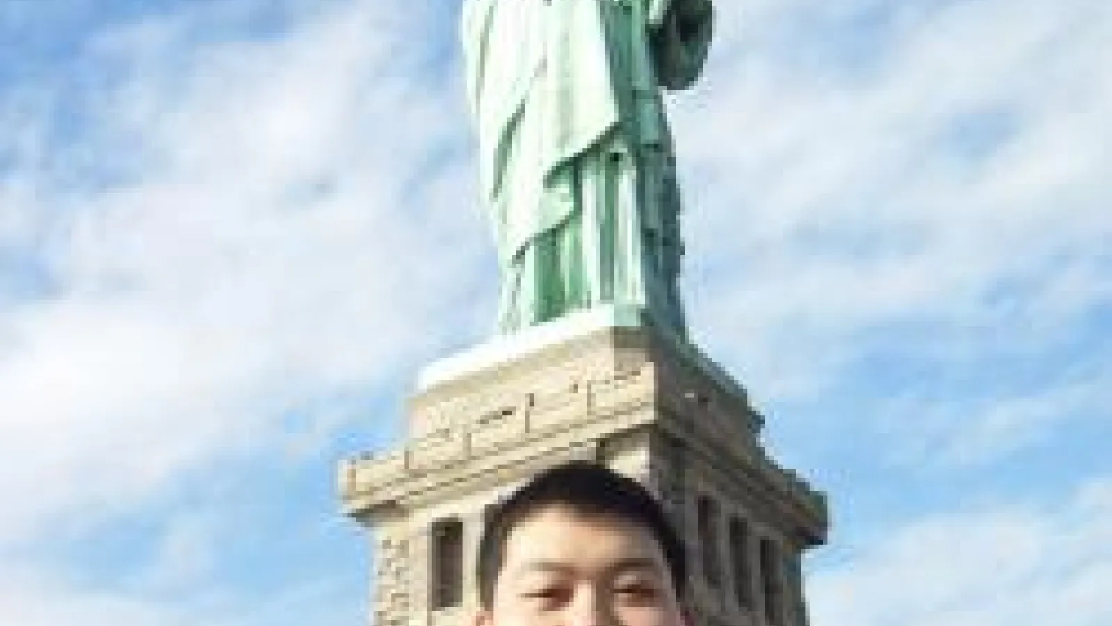 Yanfei Zhu in front of the Statue of Liberty