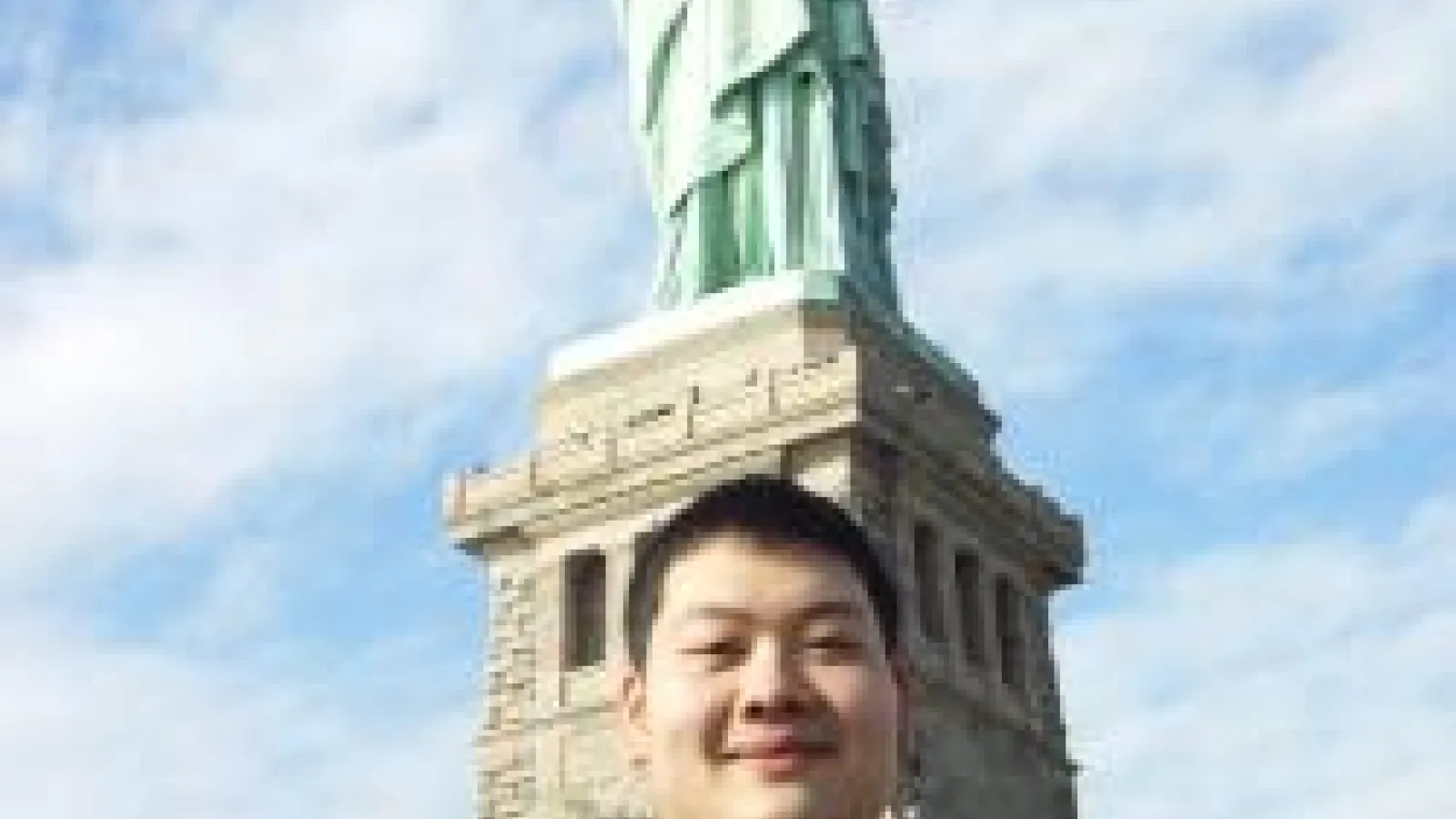 Yanfei Zhu in front of the Statue of Liberty
