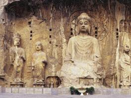 A large sculpture of the Buddha carved into the side of a cave