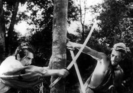 black and white image of two men fighting with swords