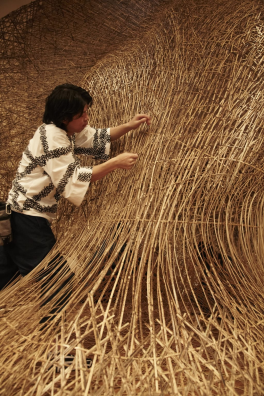 photograph of Tanabe Chikuunsai IV creating a bamboo installation