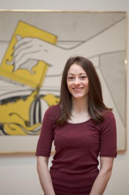 Rachel Mihalko headshot standing in front of artwork