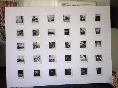 A collection of photos displayed on a white wall.
