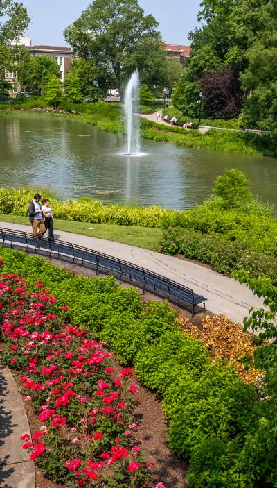A man and woman walk alongside Mirror Lake.