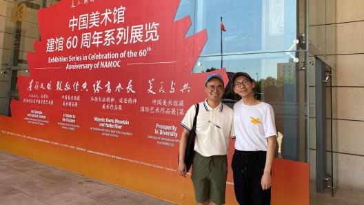 Keyu Yan (right) stands with fellow grad student Yifan Lee (left) in front of the National Art Museum of China, Bejing