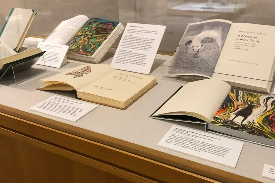 Rare books on display in cabinet with labels