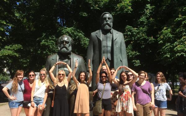Image: students in front of Marx & Engels sculpture near Alexanderplatz, Berlin