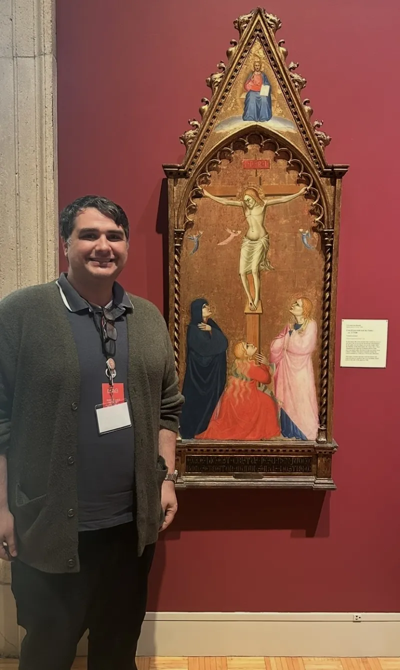Tony Del Aversano standing by Medieval artwork