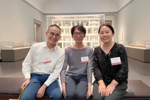 Image of  graduate students Yifan Li and Keyu Yan and PhD Alumna Effie Yin sitting and posing inside of the National Museum of Asian Art.