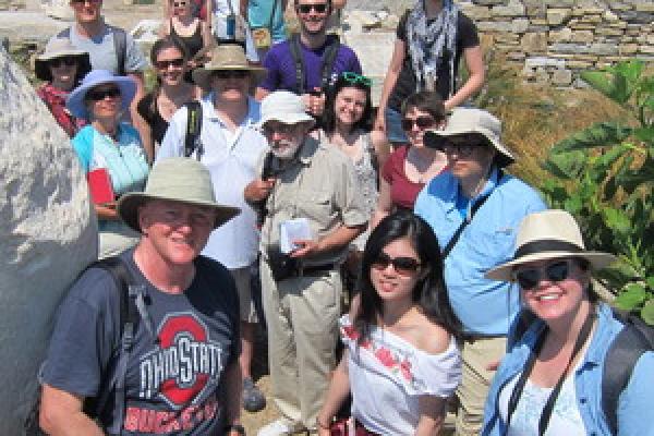 Photograph of Professor Mark Fullerton with a group of students.