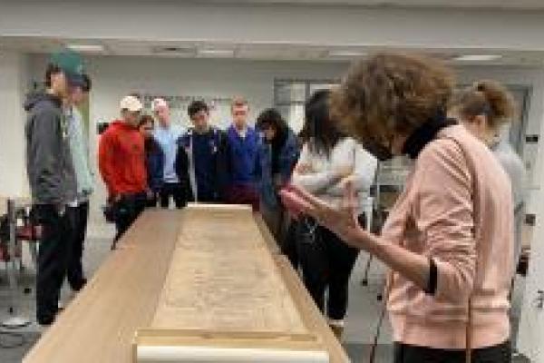 Professor Andrews and students looking at a scroll painting