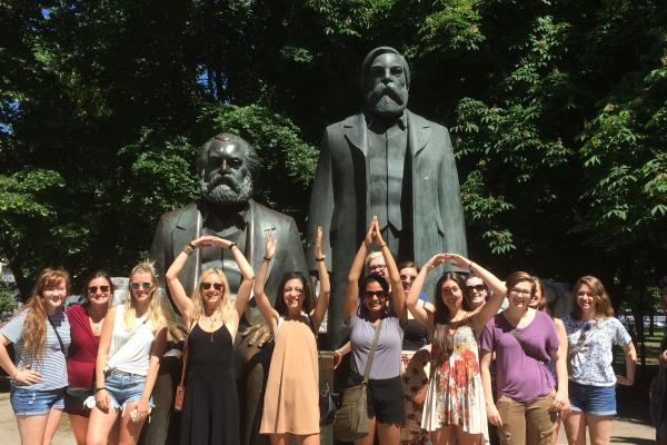 Image: students in front of Marx & Engels sculpture near Alexanderplatz, Berlin