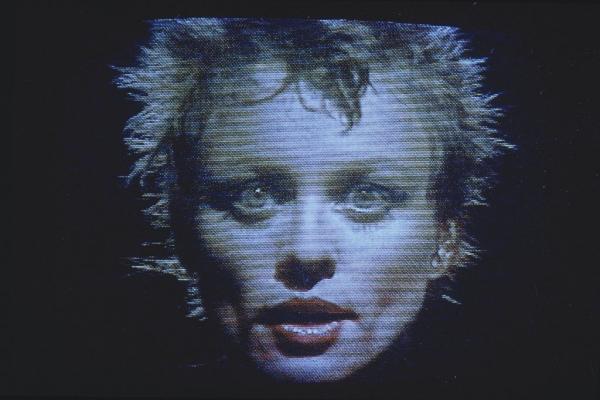 Grainy headshot photo of Laurie Anderson from the 1980s