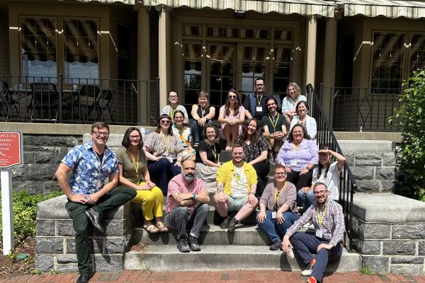 A group of people sitting outdoors on steps