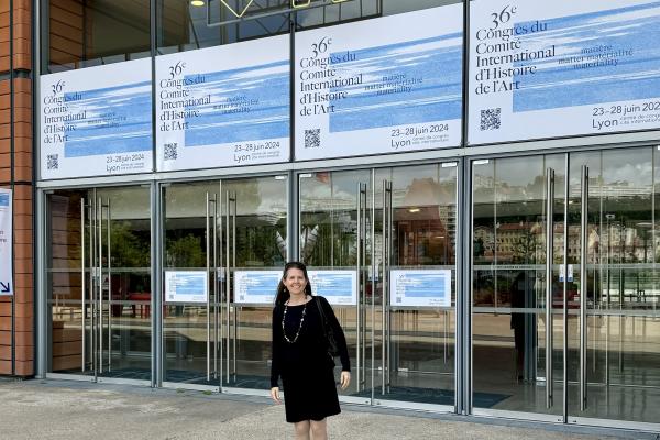 Karin Flora standing outside the entrance to the 36th Comité International d’Histoire de l’Art World Congress
