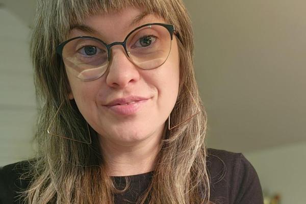 Dani Kissinger wearing a black top and glasses