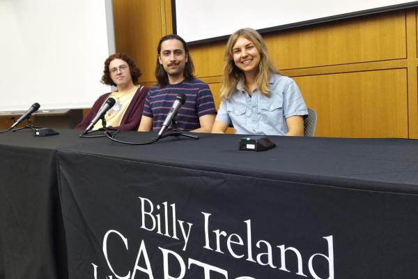 three graduate students smiling for photo at Billy Ireland panel discussion for Comic Crossroads Columbus