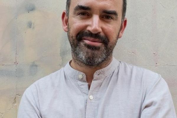 Jonathan Mullins in light shirt against light background