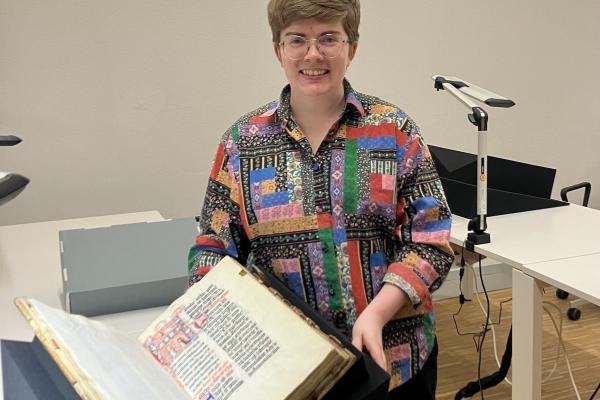 Margaret Wilson holding fifteenth century manuscript